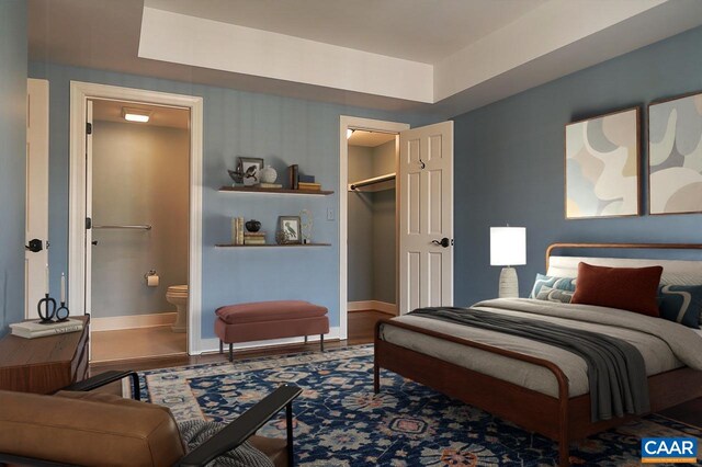 bedroom featuring baseboards and ensuite bathroom