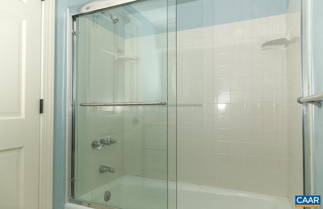 bathroom featuring bath / shower combo with glass door
