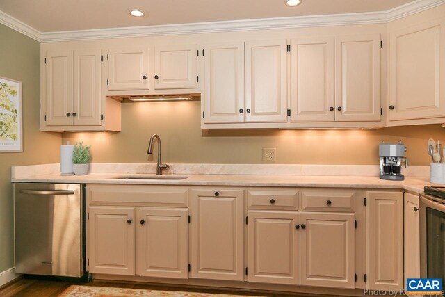 kitchen with stainless steel appliances, a sink, light countertops, crown molding, and recessed lighting