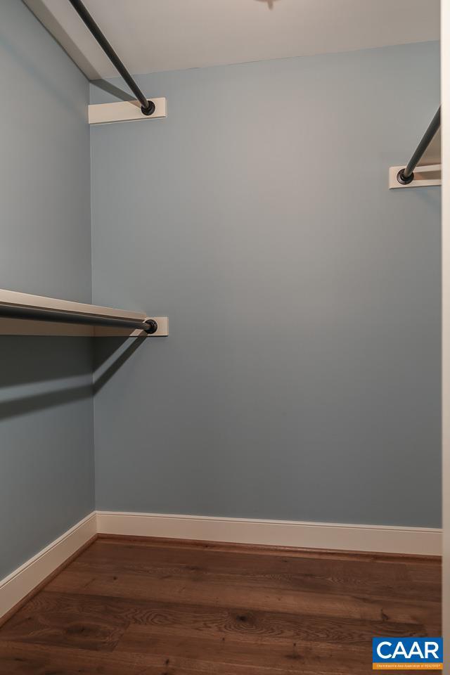 spacious closet with wood finished floors