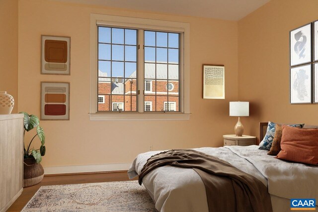 bedroom with wood finished floors and baseboards
