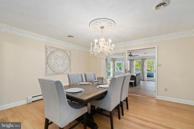  - dining area featuring a chandelier, light wood-type flooring, a baseboard radiator, baseboards, and a textured ceiling