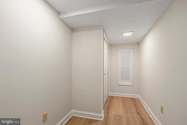  - hall featuring light wood finished floors and baseboards