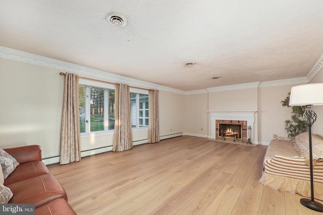  - living area with light wood-style floors, a fireplace, baseboard heating, crown molding, and baseboards