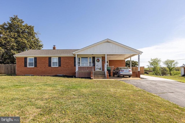 2266 Honeyville Rd, Stanley, VA 22851 - view of front of house featuring brick siding, driveway, a chimney, and a carport