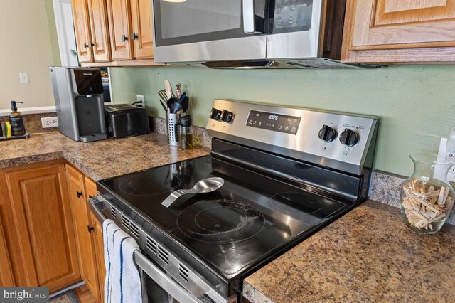 2266 Honeyville Rd, Stanley, VA 22851 - kitchen with stainless steel appliances and brown cabinetry