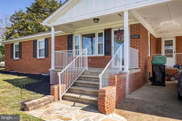 2266 Honeyville Rd, Stanley, VA 22851 - property entrance featuring brick siding, a porch, and board and batten siding