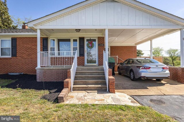 2266 Honeyville Rd, Stanley, VA 22851 - view of front facade featuring brick siding, an attached carport, covered porch, and driveway