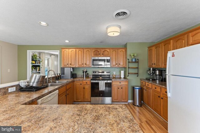 2266 Honeyville Rd, Stanley, VA 22851 - kitchen with stainless steel appliances, a sink, light wood-type flooring, a textured ceiling, and recessed lighting