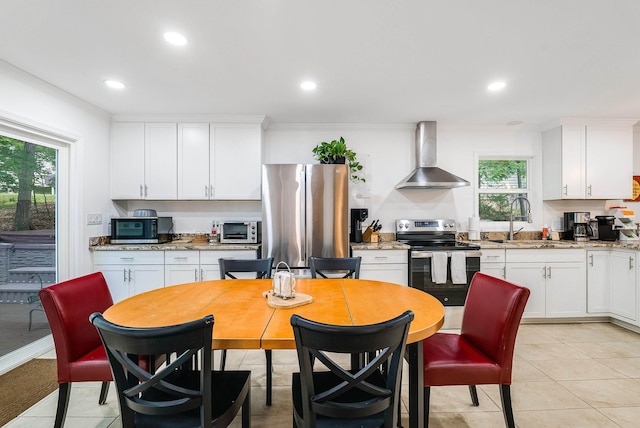 409 Cub Ln, Mcgaheysville, VA 22840 - kitchen with stainless steel appliances, wall chimney exhaust hood, healthy amount of natural light, crown molding, and white cabinetry