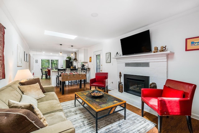409 Cub Ln, Mcgaheysville, VA 22840 - living area featuring light wood-type flooring, a fireplace, a skylight, and crown molding
