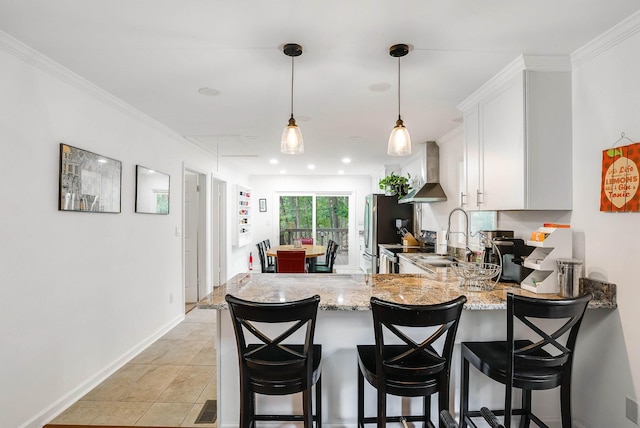 409 Cub Ln, Mcgaheysville, VA 22840 - kitchen featuring light stone countertops, a peninsula, wall chimney exhaust hood, white cabinets, and stainless steel appliances