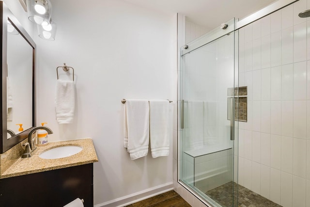 409 Cub Ln, Mcgaheysville, VA 22840 - bathroom with vanity, a stall shower, and wood finished floors