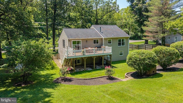  - rear view of house with a wooden deck and a yard