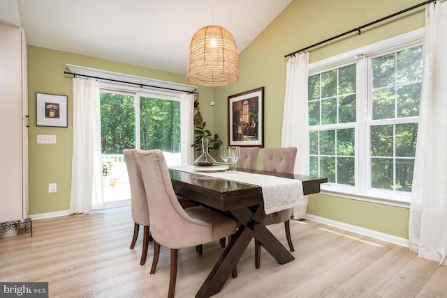 - dining space with vaulted ceiling, light wood-style floors, and healthy amount of natural light