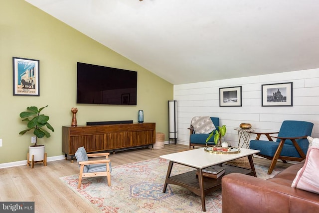  - living area with lofted ceiling and light wood-style floors