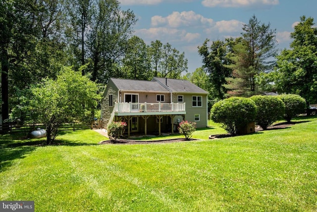  - rear view of house featuring a deck, stairway, and a yard