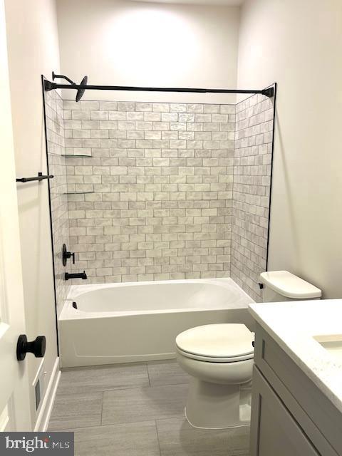 full bath featuring toilet, shower / washtub combination, vanity, and tile patterned floors