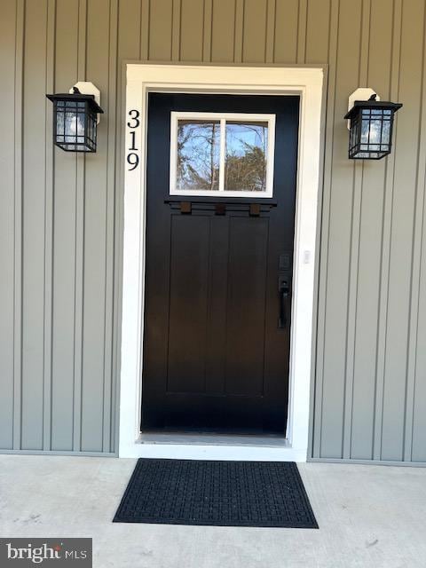 entrance to property featuring board and batten siding