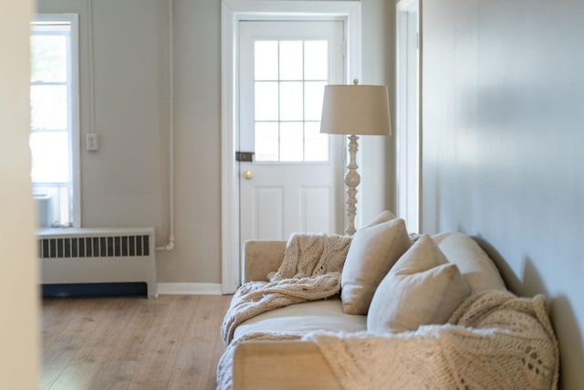 interior space featuring wood finished floors, baseboards, and radiator heating unit