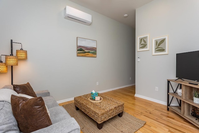 442 First St, Shenandoah, VA 22849 - living room featuring an AC wall unit, light wood-style floors, and baseboards