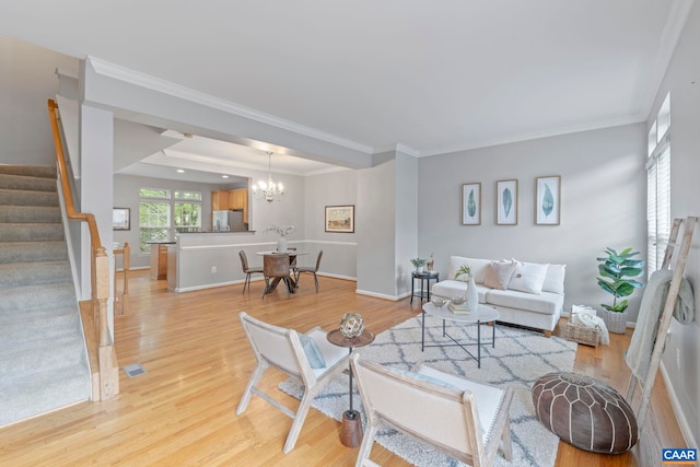 921 Bing Ln, Charlottesville, VA 22903 - living room featuring stairs, light wood-style flooring, crown molding, and a chandelier