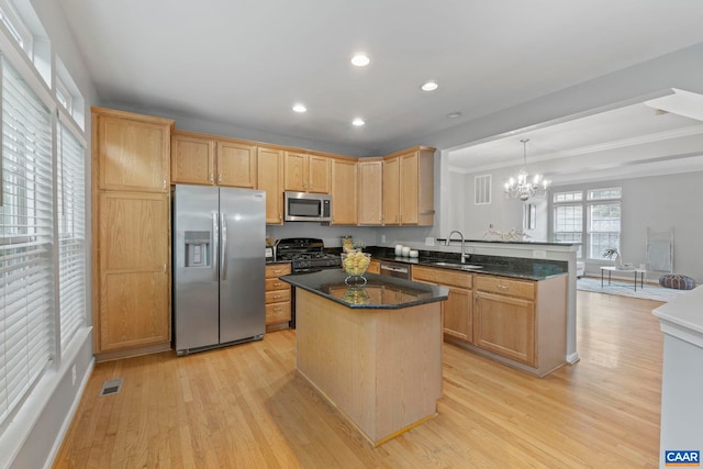 921 Bing Ln, Charlottesville, VA 22903 - kitchen featuring appliances with stainless steel finishes, a peninsula, light wood-type flooring, ornamental molding, and a chandelier