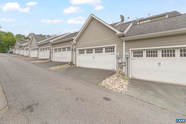 921 Bing Ln, Charlottesville, VA 22903 - view of property exterior with a shingled roof and asphalt driveway