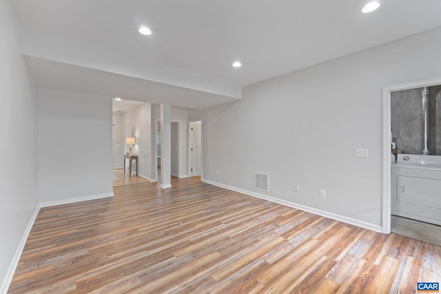 921 Bing Ln, Charlottesville, VA 22903 - spare room with washer / clothes dryer, light wood-style floors, and recessed lighting