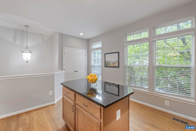 921 Bing Ln, Charlottesville, VA 22903 - kitchen with light wood-style flooring, dark stone countertops, a kitchen island, decorative light fixtures, and recessed lighting