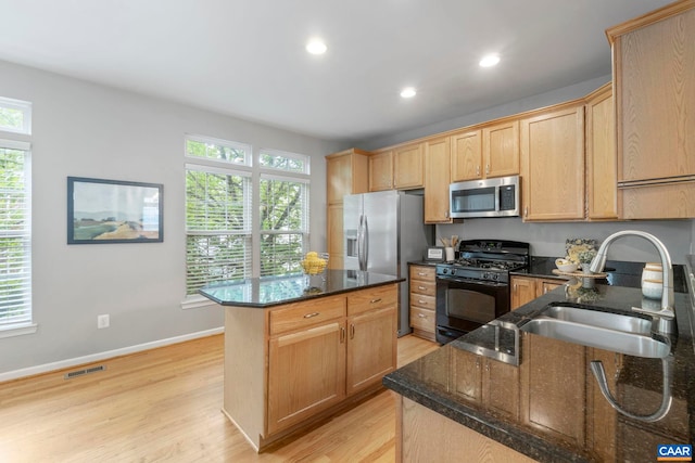 921 Bing Ln, Charlottesville, VA 22903 - kitchen featuring appliances with stainless steel finishes, light wood finished floors, a center island, dark stone countertops, and recessed lighting