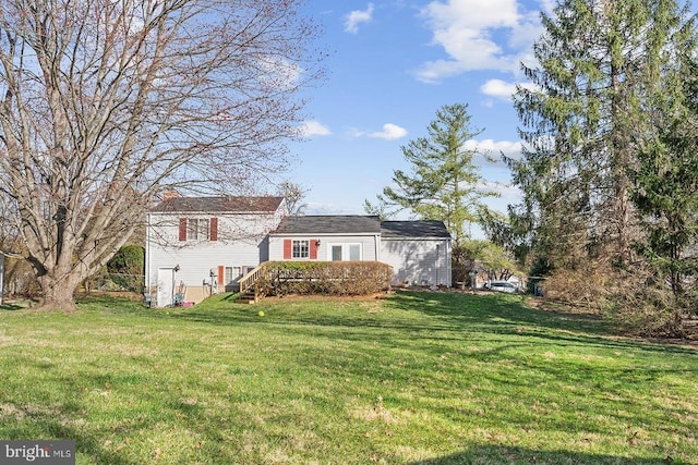  - view of front of property featuring a front lawn, a deck, and a chimney