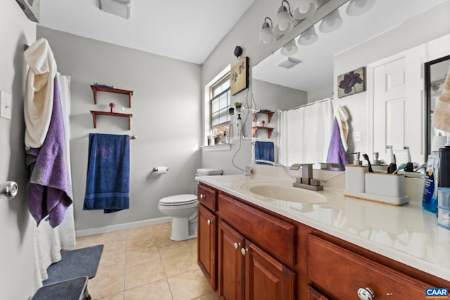 bathroom featuring toilet, visible vents, baseboards, tile patterned flooring, and vanity