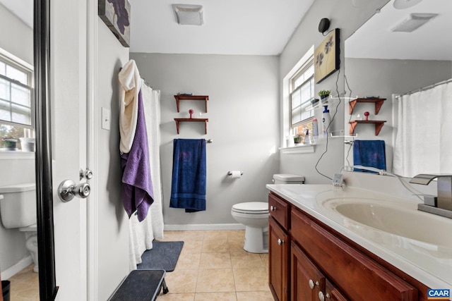 full bath featuring vanity, toilet, baseboards, and tile patterned floors