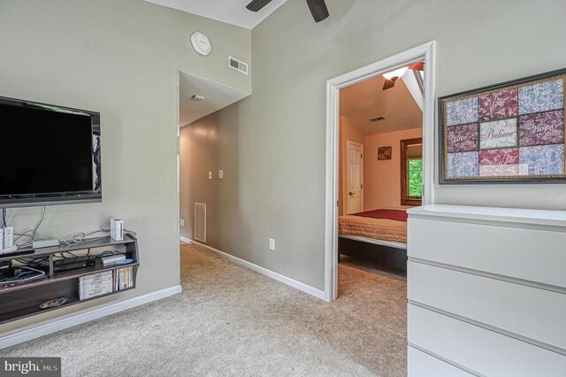 bedroom with light colored carpet and baseboards