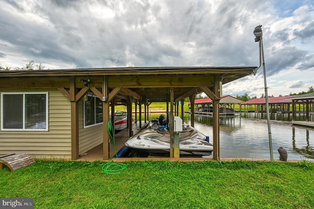 dock area featuring a yard, a water view, and boat lift