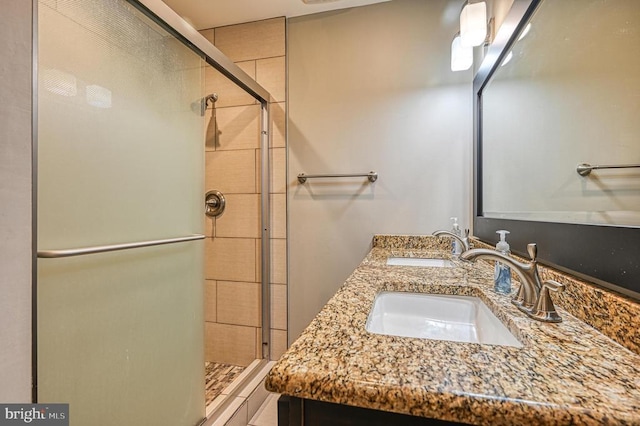 bathroom with a stall shower and double vanity