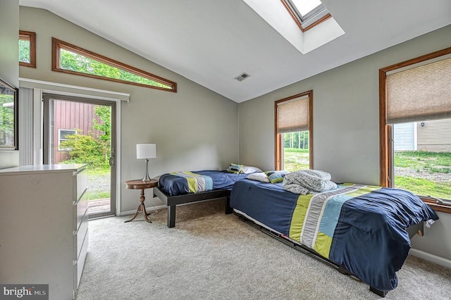bedroom with a skylight, vaulted ceiling, access to exterior, carpet, and multiple windows