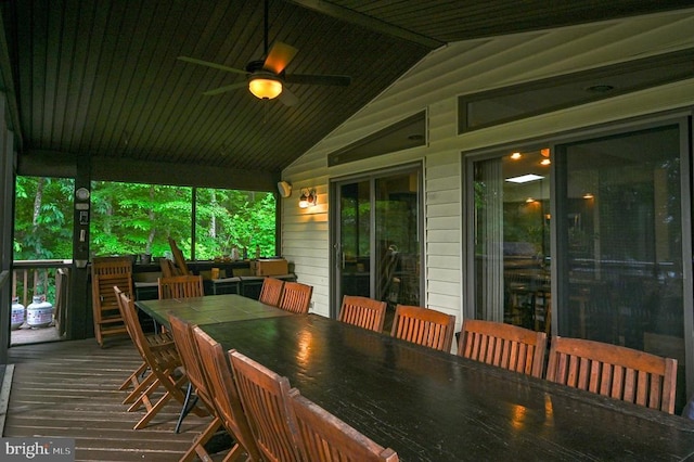 wooden terrace featuring a ceiling fan and outdoor dining space