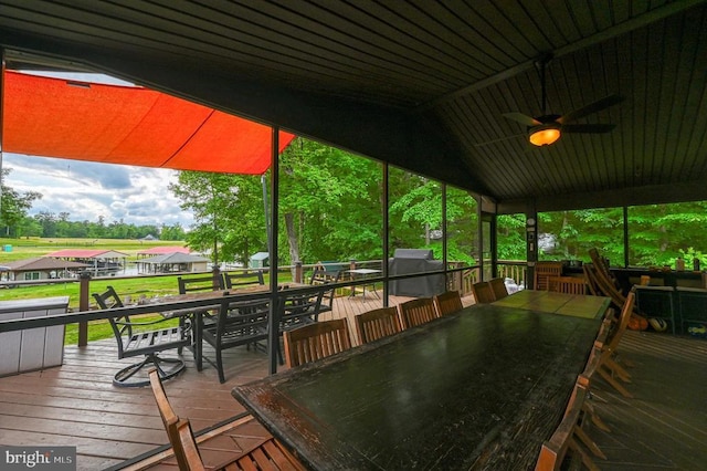 deck with outdoor dining area and a ceiling fan