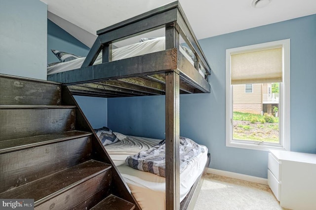 unfurnished bedroom featuring carpet flooring and baseboards