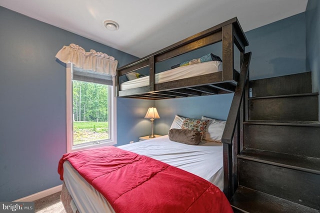 bedroom with carpet floors and baseboards