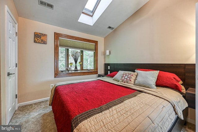 carpeted bedroom featuring a skylight, vaulted ceiling, and baseboards