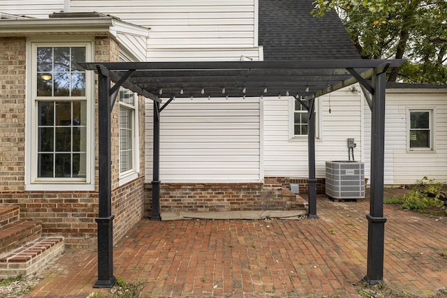 view of patio featuring central air condition unit and a pergola