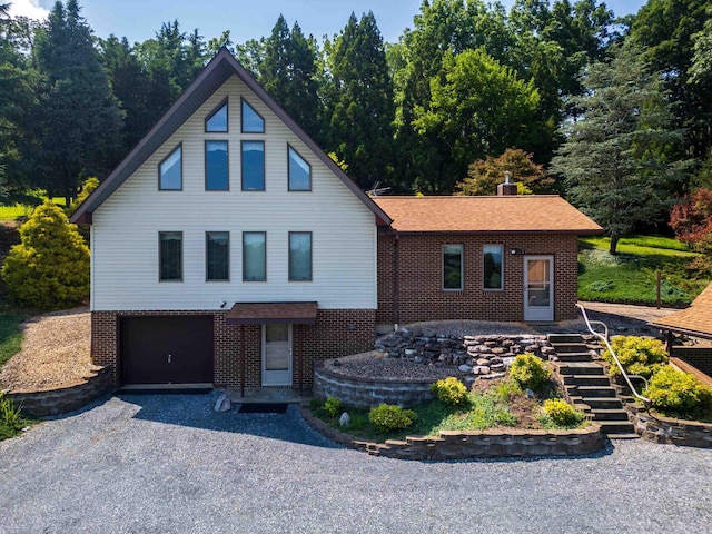 613 Dices Spring Rd, Weyers Cave, VA 24486 - view of front facade featuring brick siding, stairway, gravel driveway, a garage, and a shingled roof