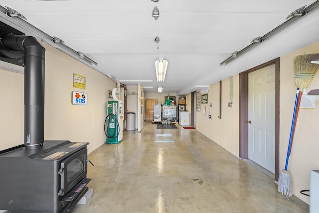 613 Dices Spring Rd, Weyers Cave, VA 24486 - garage featuring electric water heater and a wood stove