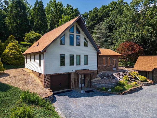 613 Dices Spring Rd, Weyers Cave, VA 24486 - view of front facade featuring driveway, a garage, brick siding, and a shingled roof