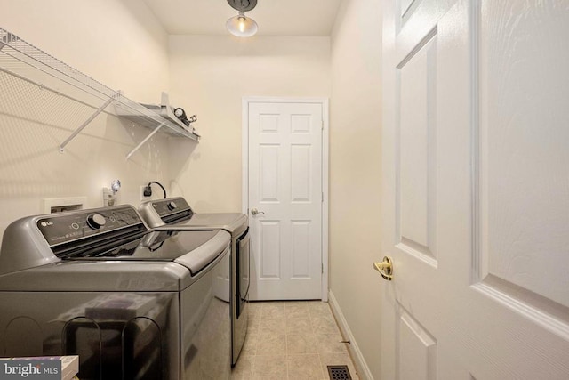 10207 Iverson Ave, Fredericksburg, VA 22407 - laundry area with washer and clothes dryer, light tile patterned floors, and baseboards