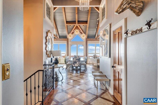 380 Blackrock Cir, Wintergreen Resort, VA 22967 - corridor with inlaid floor details, a textured wall, beam ceiling, a towering ceiling, and an upstairs landing