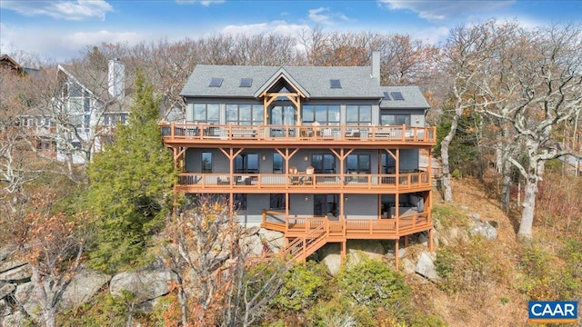380 Blackrock Cir, Wintergreen Resort, VA 22967 - rear view of property with a shingled roof, a chimney, and a deck